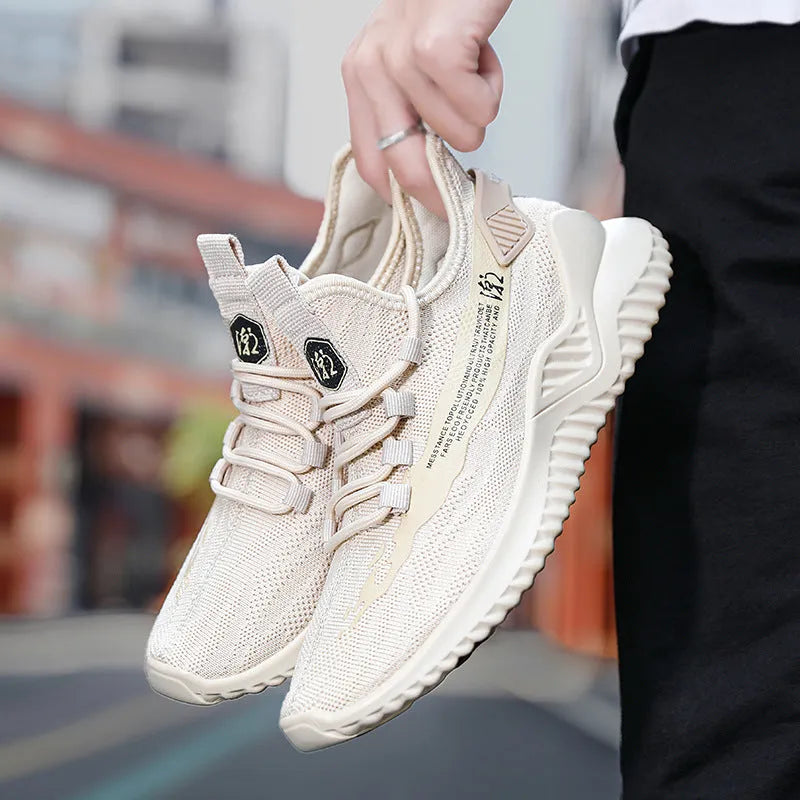 Men's white mesh sports shoes with rubber sole and low-cut design on neutral background