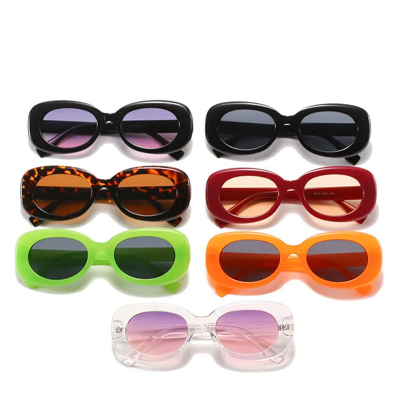 Oval fashion sunglasses for women with black PC frame and UV400 AC lenses