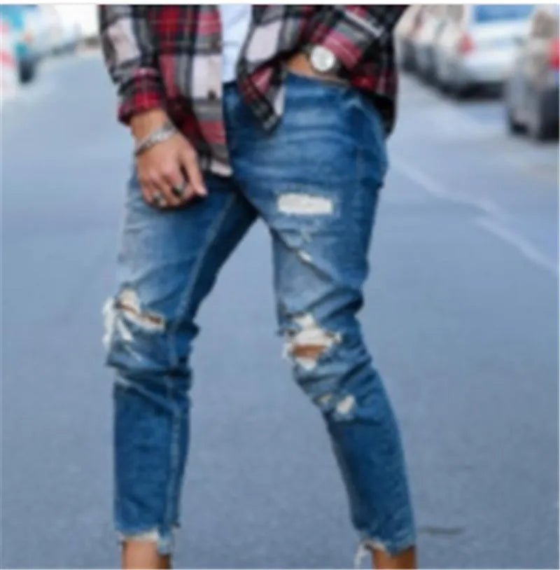 Men's deep blue distressed jeans with hole details on the legs.