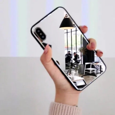 Black iPhone case with a built-in mirror on the back, compatible with iPhone X and iPhone 7 Plus models.