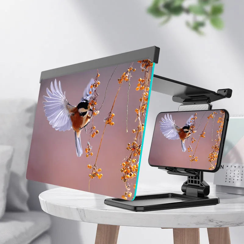 Black folding mobile phone screen magnifier with detachable holder on a desktop.