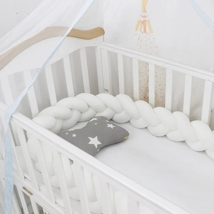 Multi-colour baby crib bumper made of spandex velvet, shown bent around a crib edge.