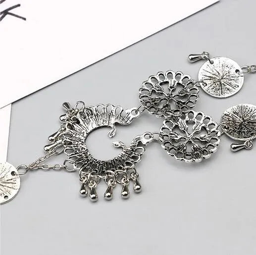 Antique silver hollow flower chain anklet with teardrop shape on a surface, 24cm foot jewellery for women