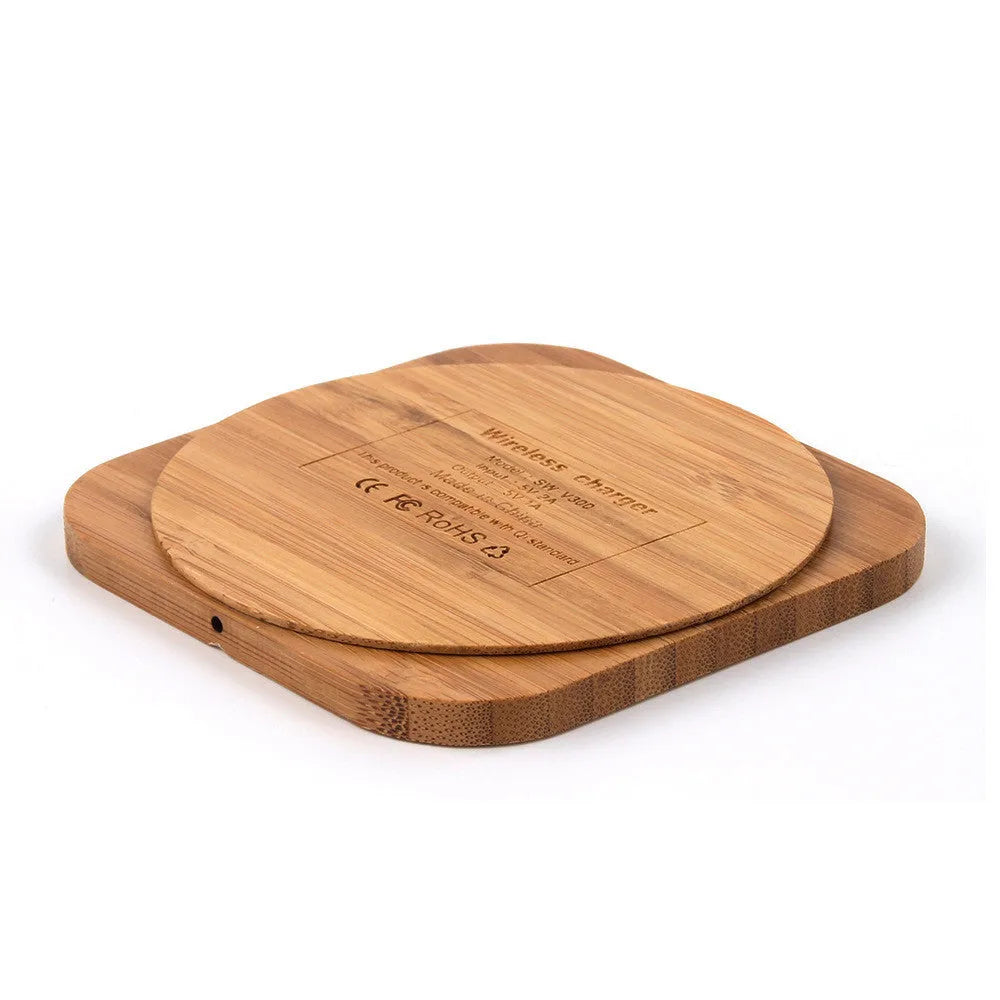 Brown wooden bamboo square 5W wireless charging pad on a desk.