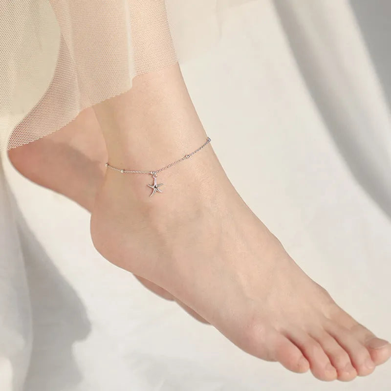 Women's sterling silver S925 anklet with a starfish charm and round bead on an adjustable chain.