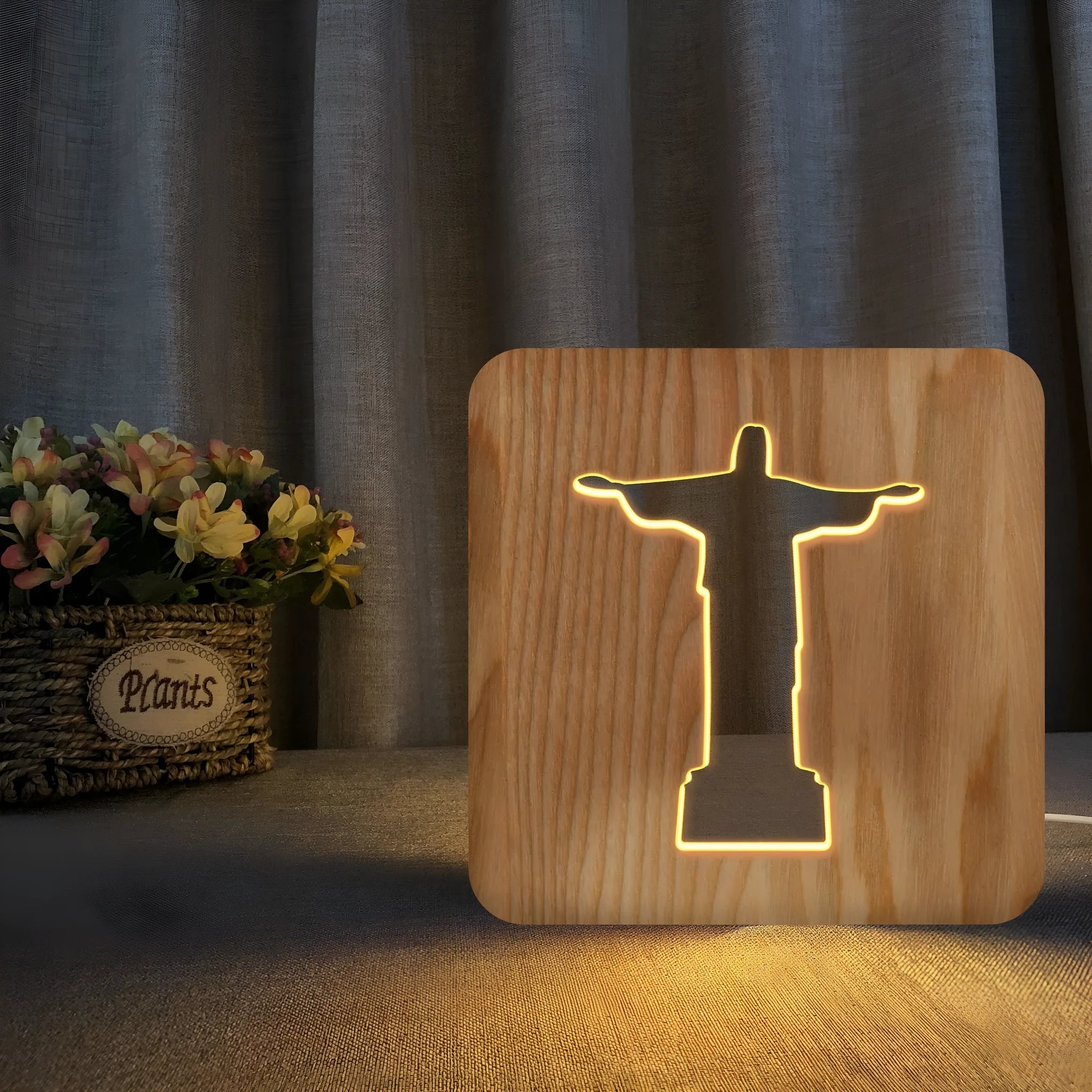 Solid wood hollow night lamp with warm white LED light on a surface.