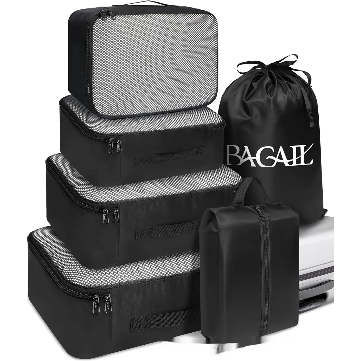 Eight cubic travel packing bags in various colours including beige, black, pink leopard print, and white pink stripes