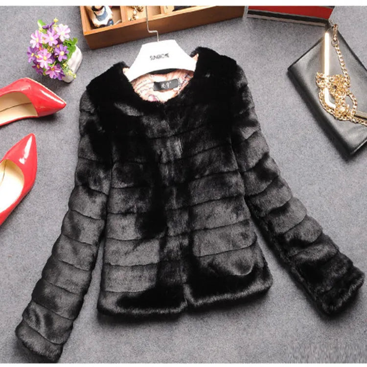 Women's short faux fur top in beige on a hanger, showing regular sleeves and textured fabric.