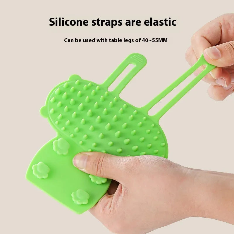 Silicone cat grooming brush mounted on table leg with adjustable strap, available in four colours