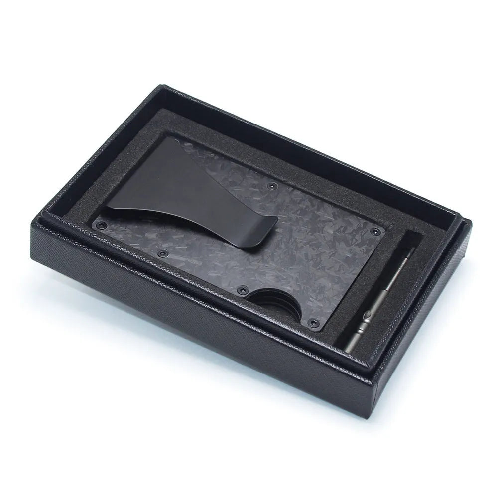 Slim black carbon fibre card holder wallet with geometric design on a table.