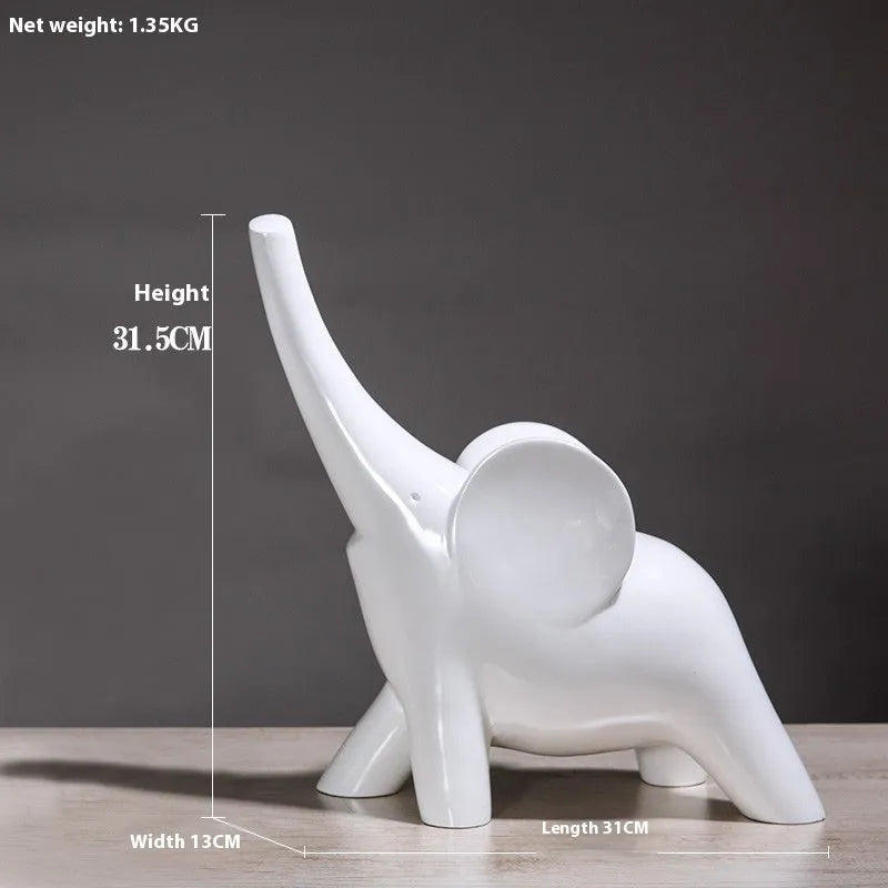 Modern minimalist solid resin elephant ornament in rose gold or white finish on a shelf.