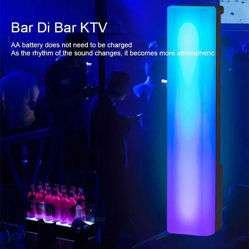 Tall 3D RGB LED ambience lamp with colourful lights on a desk, showcasing its voice-activated music rhythm mode.