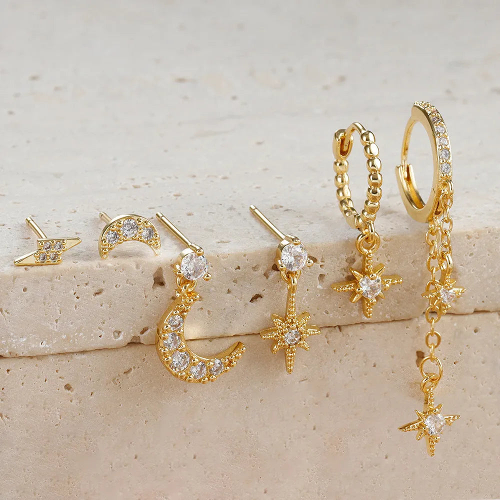 Six pairs of gold chain tassel earrings with zircon studs in display layout
