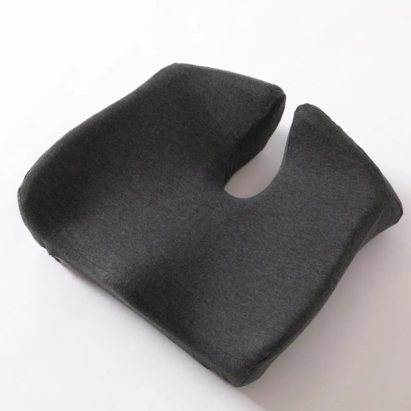 Black memory foam office chair cushion with a solid colour polyester cover, shown on a chair seat.
