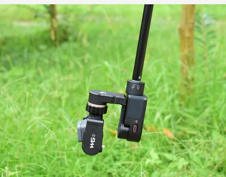 Black retractable metal selfie stick with hand-held stabilizer extended for smartphone photography