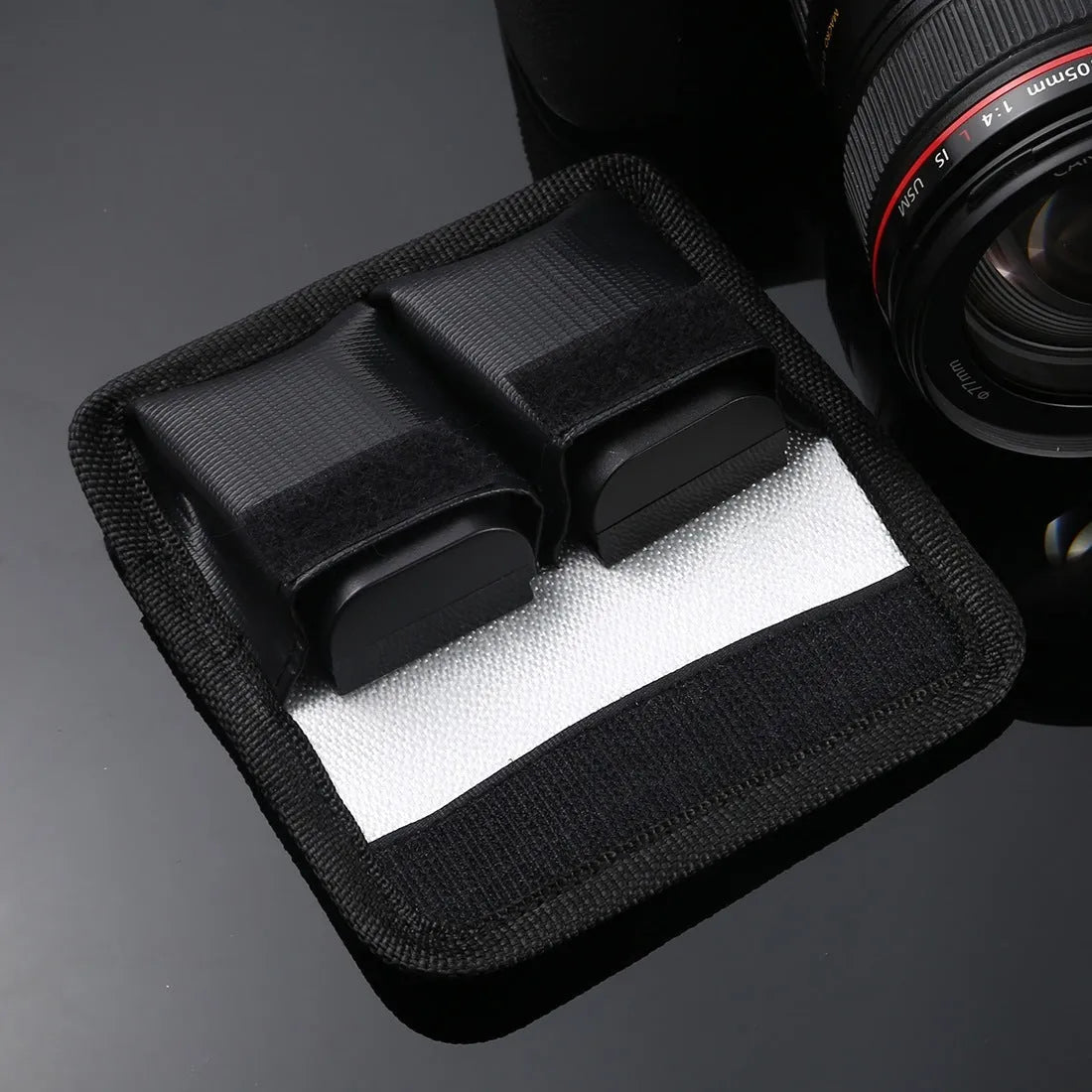 Black explosion-proof lithium battery storage bag with magic tape closure on a white background