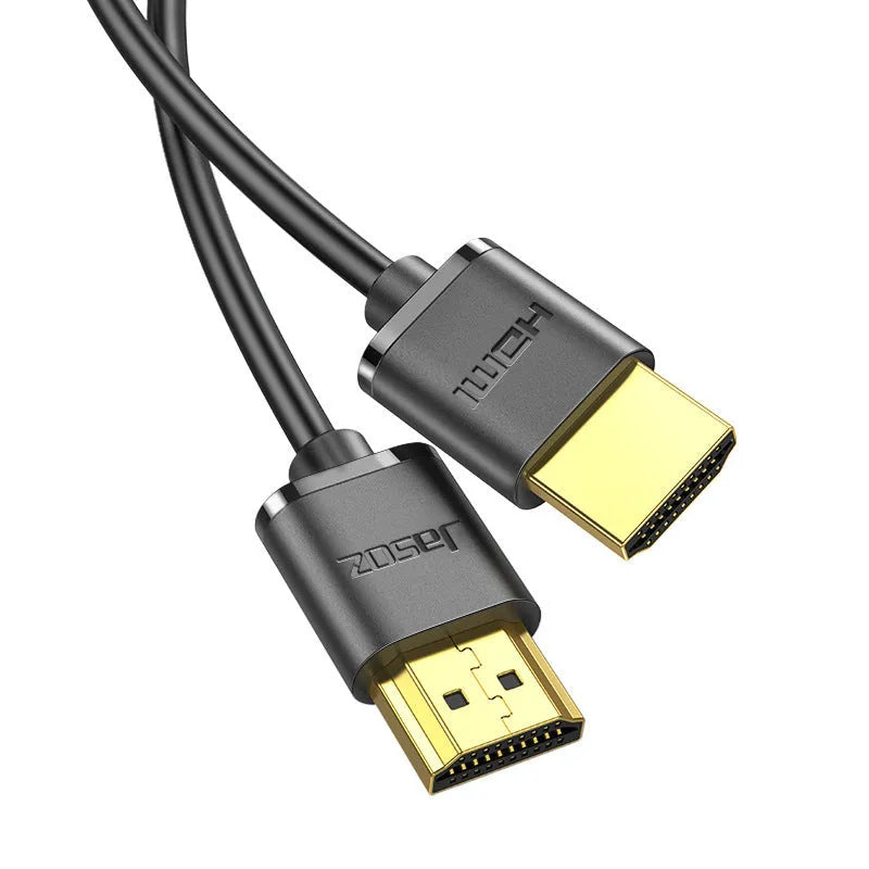 Flexible thin HDMI cable with gold-plated connectors and HDMI hairline rule design on a white background.
