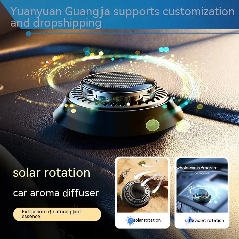 Solar powered kinetic car air freshener with rotating double rings on black plastic base