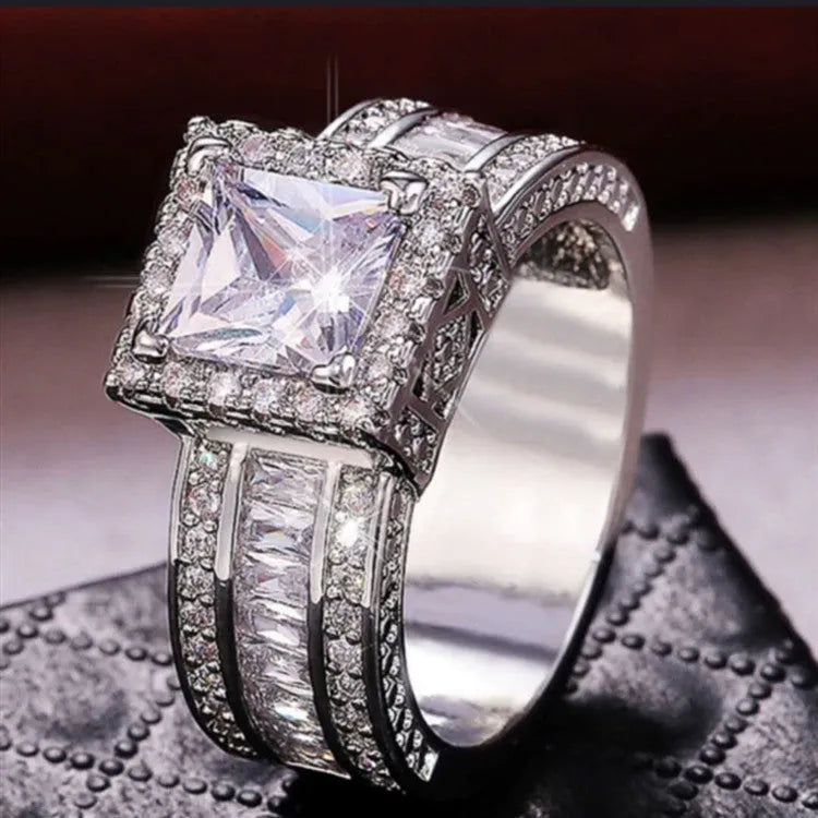 Women's silver geometric engagement ring with electroplated gold or white finish and round design