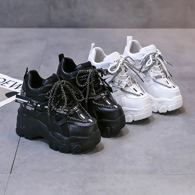 Women's white mesh platform sports shoes with cross strap and a high rubber sole.