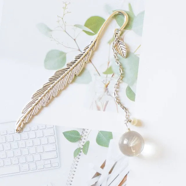 Dried flower specimen encased in metal alloy bookmark pendant measuring 12cm by 2cm