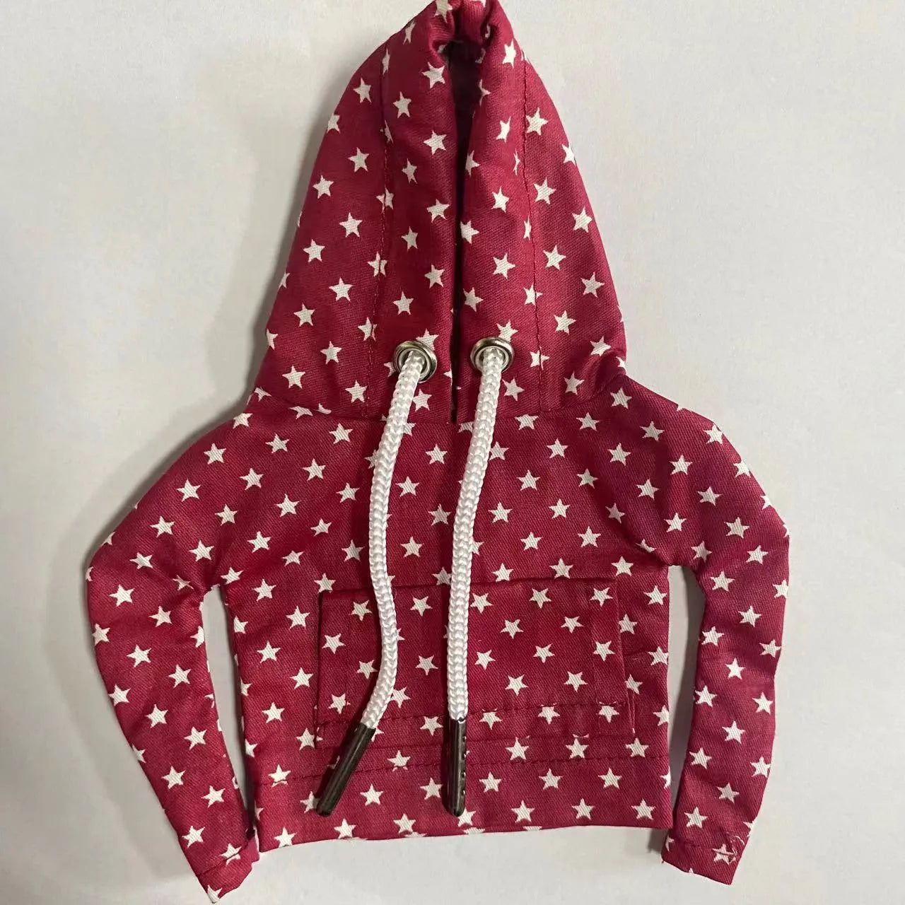 Multicolour cotton handbrake cover hooded over a car gear lever.