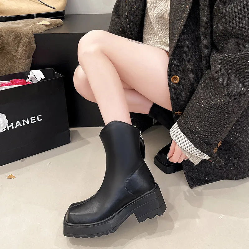 Black platform Martin boots for women with square toe and back zipper on a white background.