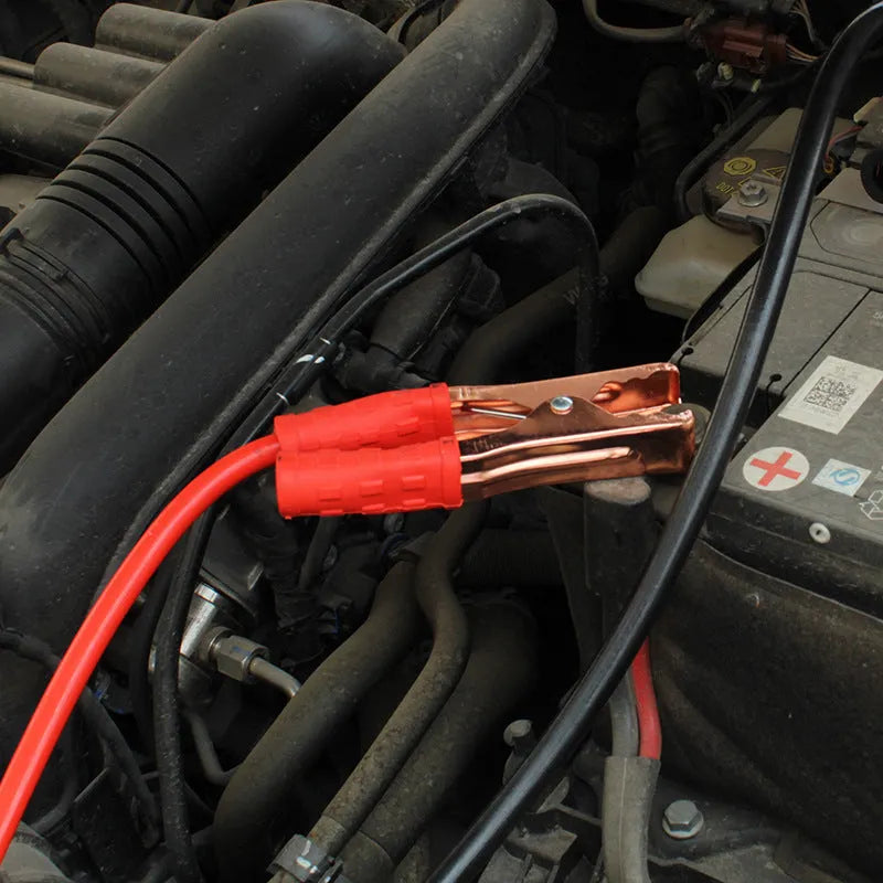 Black and red car battery jumper cables with clips for emergency vehicle jump-starting