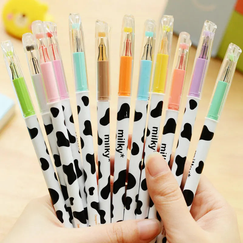 Box of 12 cow colour gel pens with 0.38mm fine tips on a desk.