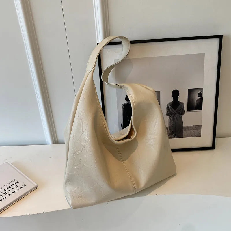Soft PU leather shoulder bag with sewing thread accents and sandwich pocket design