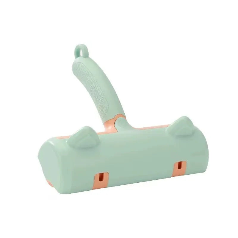 Mint green manual brush for removing cat hair from furniture and fabrics, showing its size.