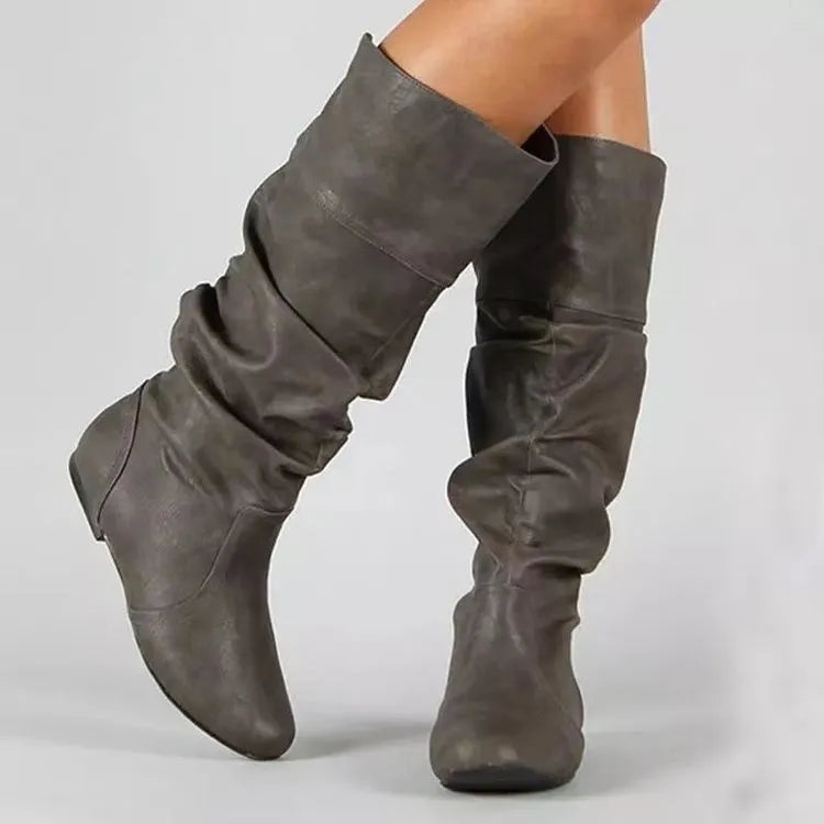 Women's slip-on knee high flat boots in artificial PU upper with round toe and rubber sole