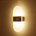 Magnetic rechargeable wall lamp in arc style, black finish, with warm light on a metal bedside shelf