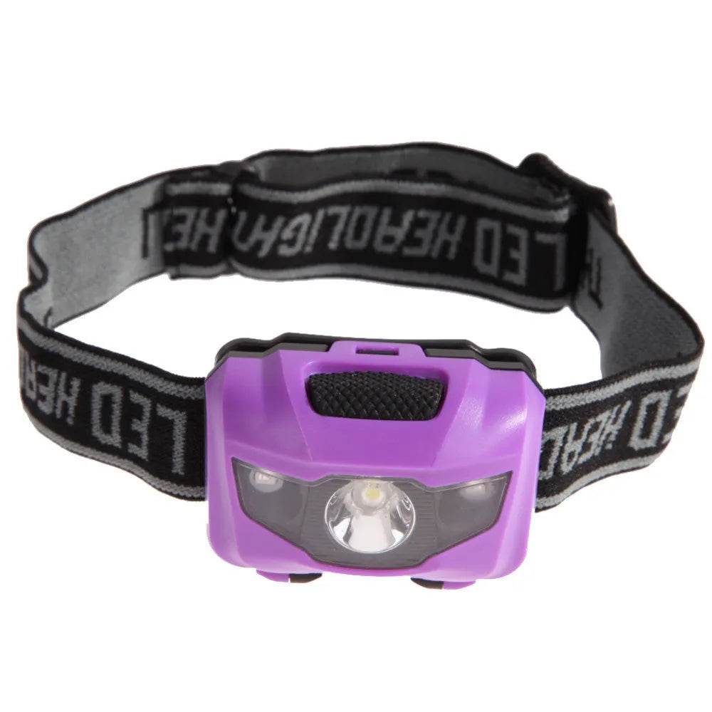 A black waterproof head torch with a central white LED and two smaller red LEDs, mounted on an adjustable headband.