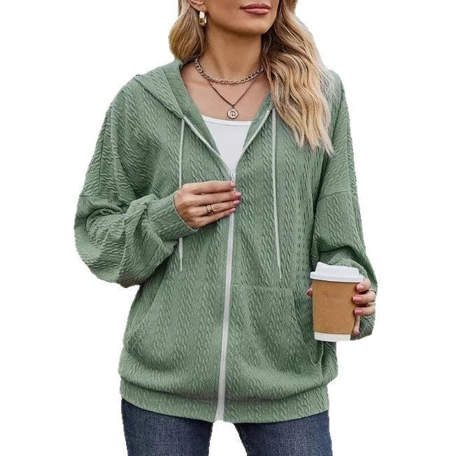 Green women's hooded zip-up sweater coat with long sleeves on a hanger.