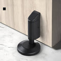 Zinc alloy invisible door stopper in brushed nickel finish on wooden floor.