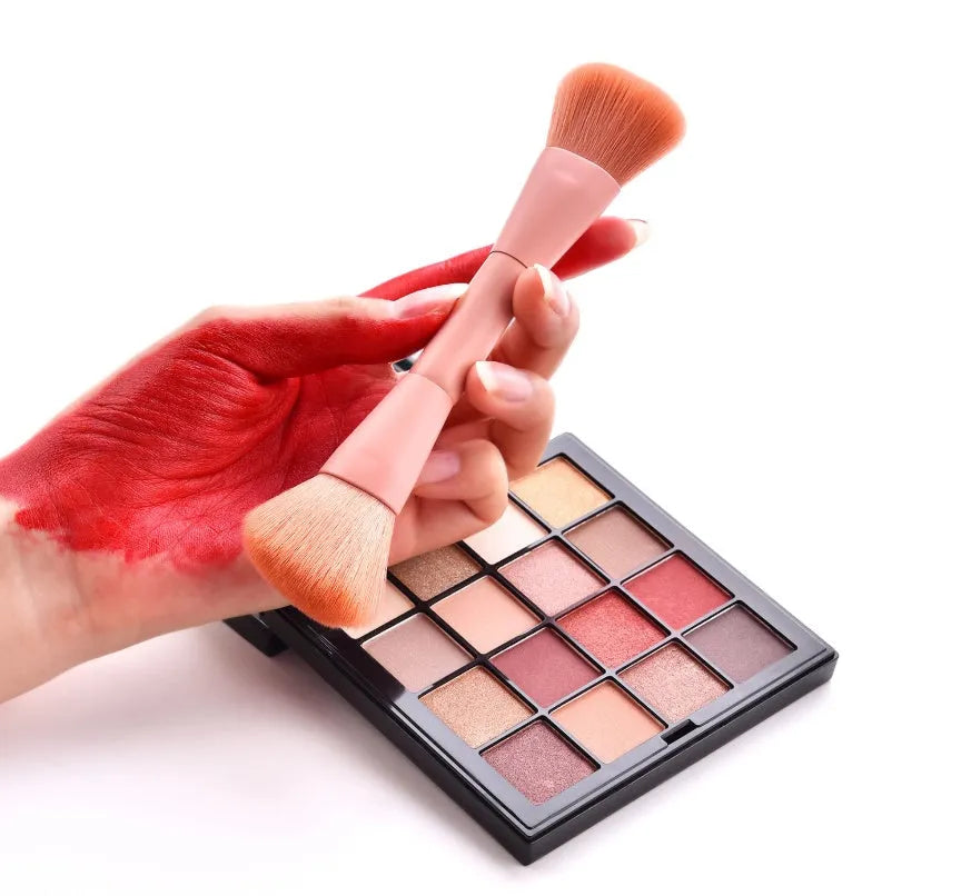 Ten professional makeup brushes with wooden handles arranged by size for different cosmetic applications