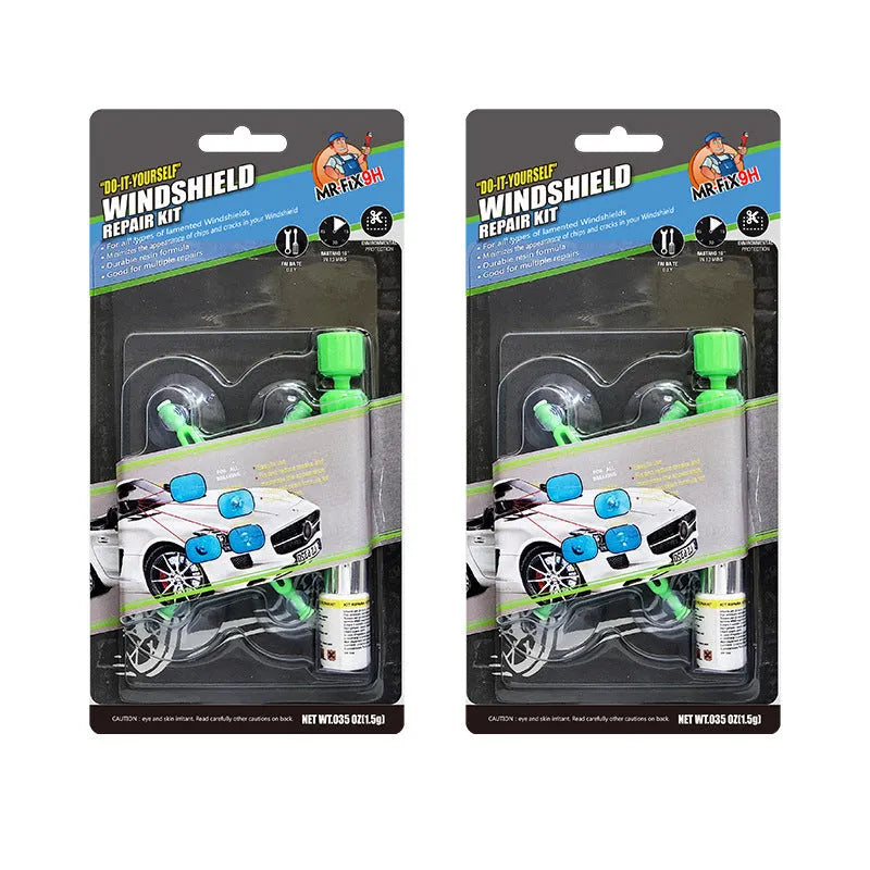 Windshield repair fluid kit with green resin, repair device, curing strips, and sleeved razor blade on a car windscreen