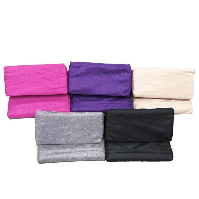 Candy-shaped tablet and phone support pillow with slow rebound fill, beige colour, on a bed