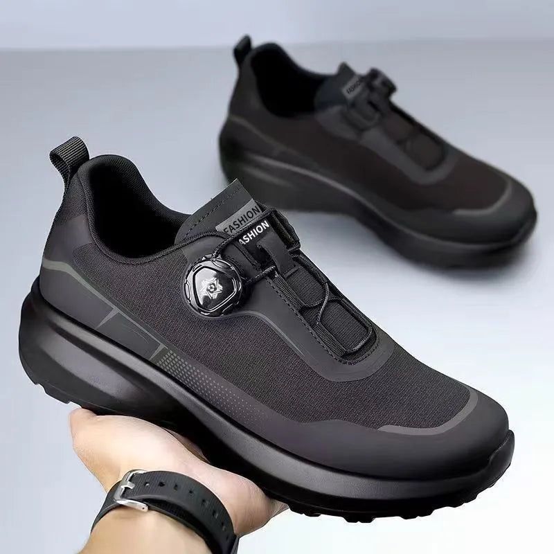 Men's black casual sneakers with a rotating button closure and thick platform sole.