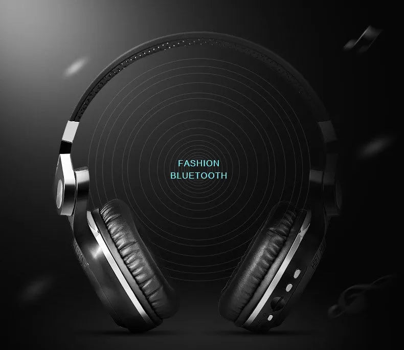 Black Bluetooth headset with in-line controls and a subwoofer, shown in a head-mounted position.