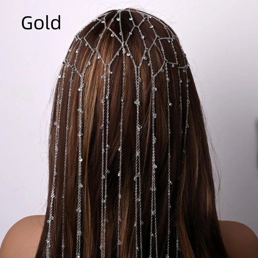 Gold rhinestone headband with mesh tassel detail on a white background.