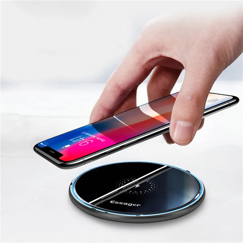 Black or white aluminium wireless charging pad showing soft LED light, for phones and headphones.