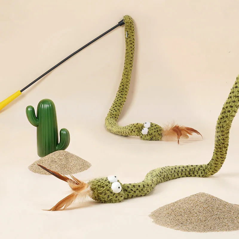 Green cat teasing stick with long pole showing artificial snake and feather attachments for interactive play