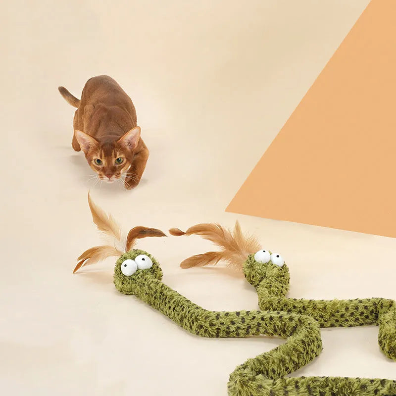 Green cat teasing stick with long pole showing artificial snake and feather attachments for interactive play