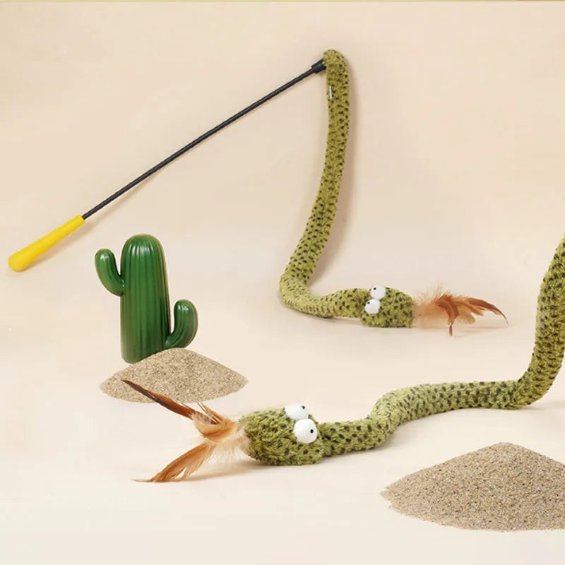 Green cat teasing stick with long pole showing artificial snake and feather attachments for interactive play