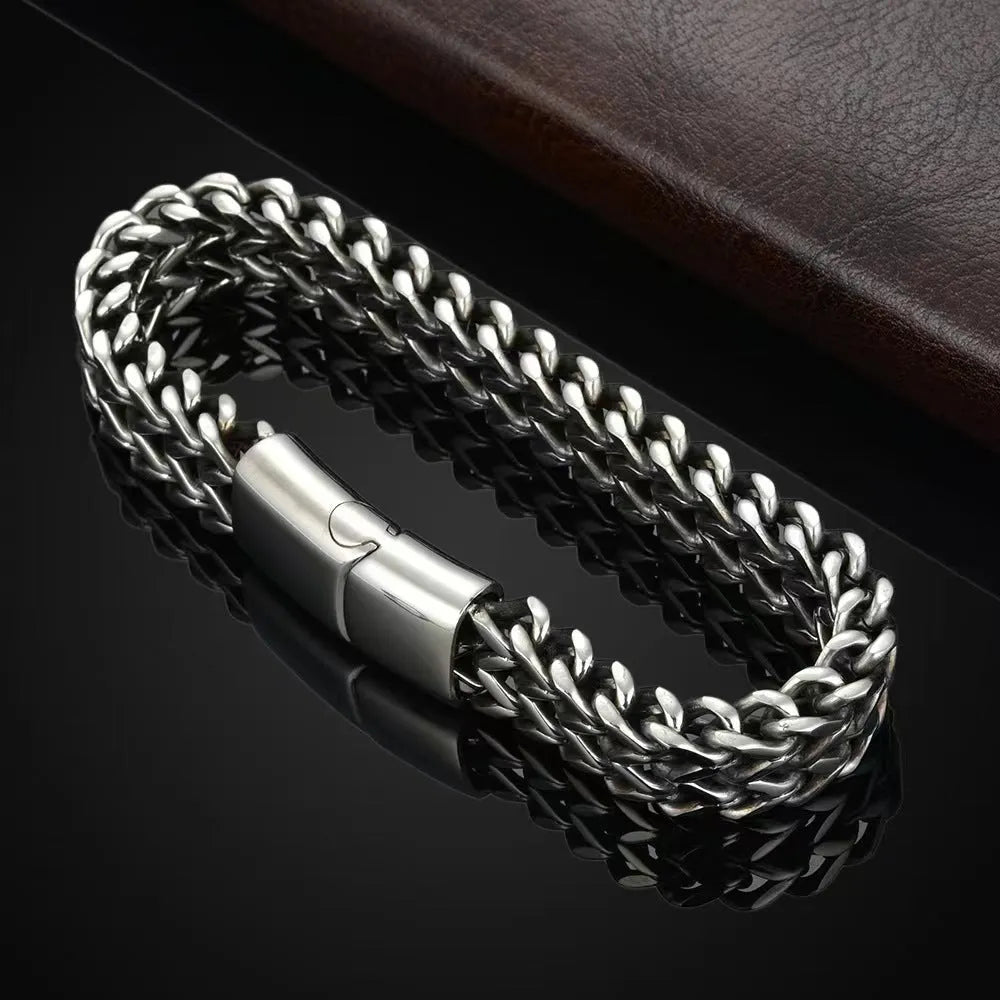 Men's geometric stainless steel bracelet showing front and back patterning with silver finish