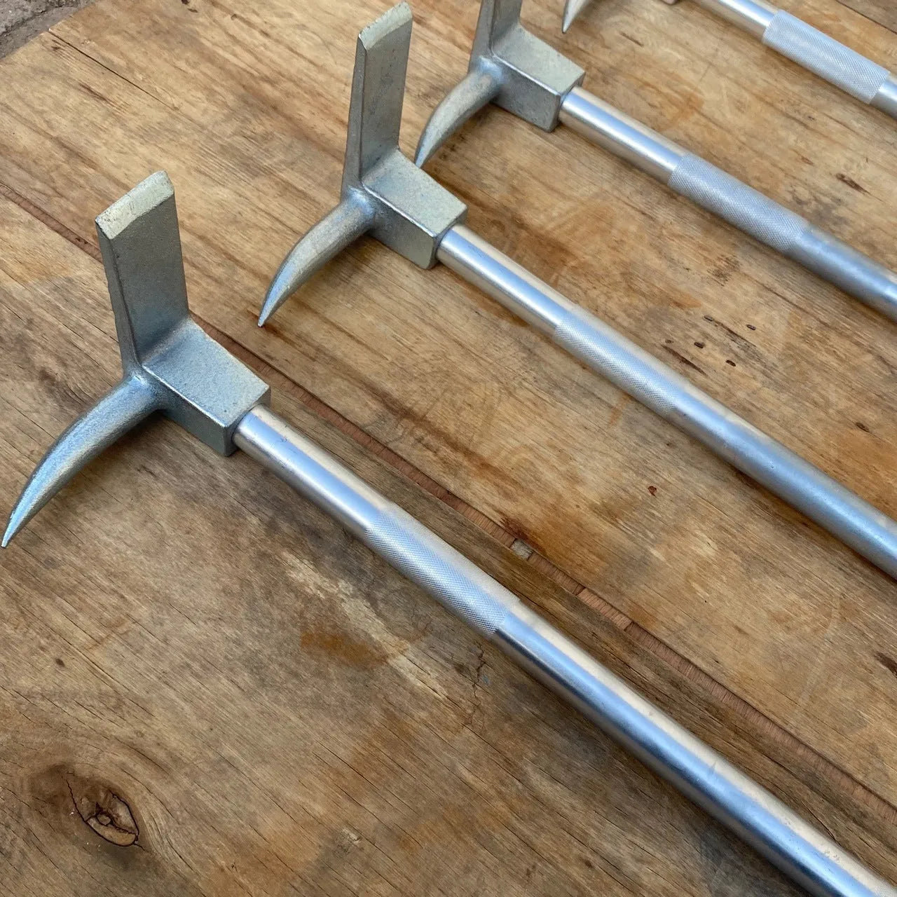 Silver carbon steel wrecking bar 24 inches with iron collar on a dark surface