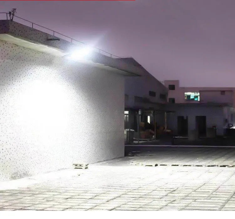 Black solar-powered outdoor security light with motion sensor for garden and driveway illumination