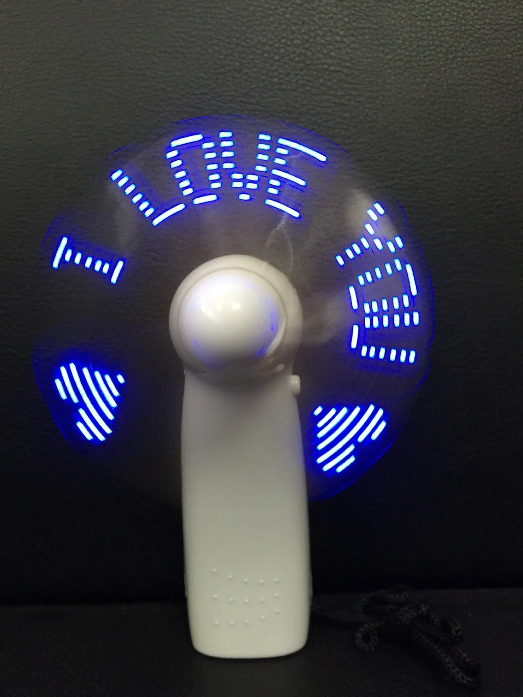 White handheld mini fan with flashing blue and red LED love pattern lights